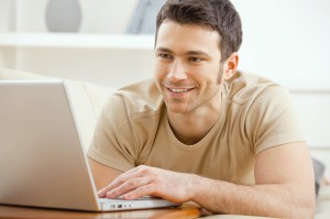 young-man-watching-video-on-laptop