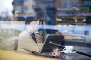 young-woman-on-tablet-in-coffeehouse