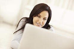 Woman-watching-video-ads-on-laptop